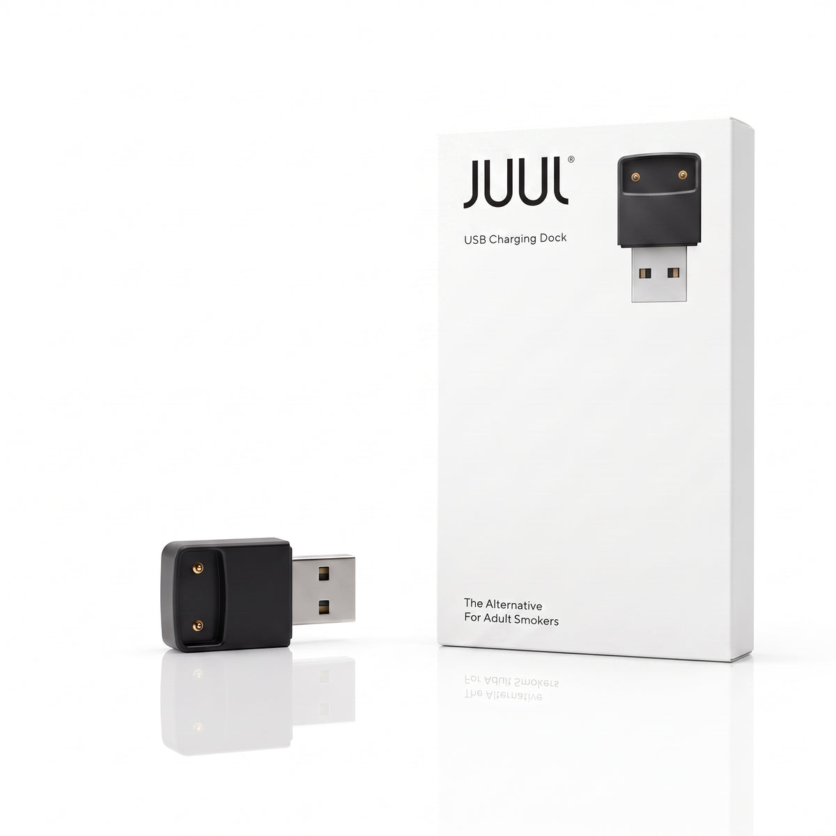 A black USB charging dock shown next to its white retail box on a clean white background. The box features the JUUL brand name and a graphic of the charging dock.