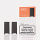 Two JUUL 2 disposable vape devices in black are displayed next to their peach and white packaging box on a light gray reflective surface. The packaging features the JUUL 2 brand name and a prominent nicotine warning label.